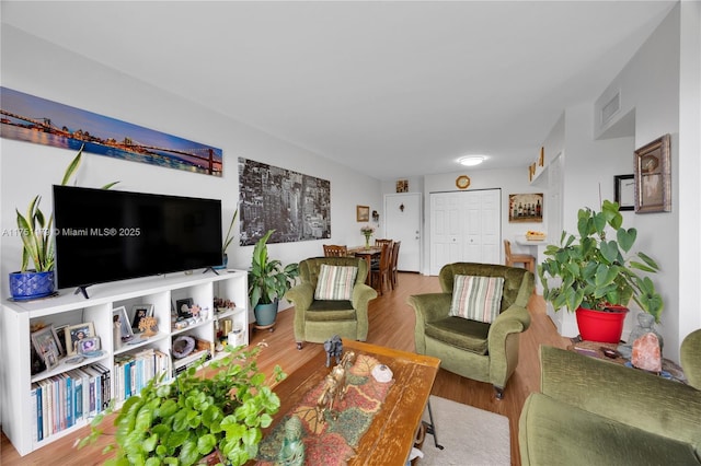 living room featuring wood finished floors and visible vents