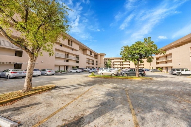 view of building exterior with uncovered parking