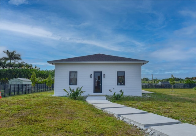 bungalow-style home with a front yard and fence