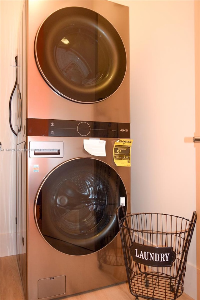 laundry room featuring stacked washer / drying machine and laundry area