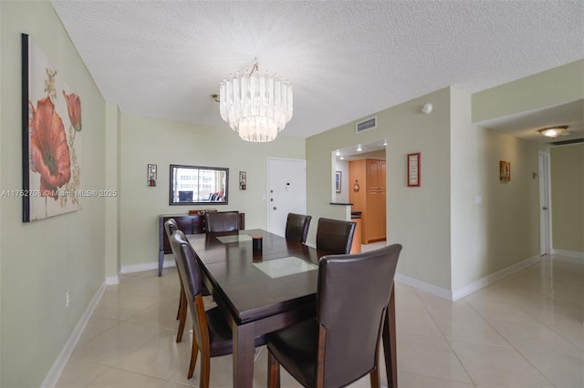 dining space with visible vents, a textured ceiling, and light tile patterned flooring