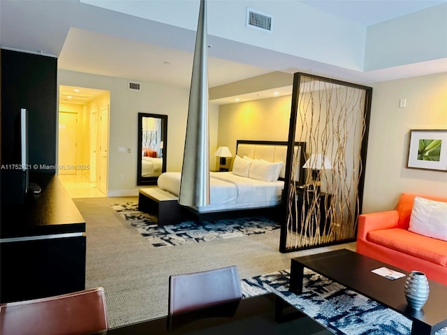 bedroom featuring carpet floors, visible vents, and baseboards