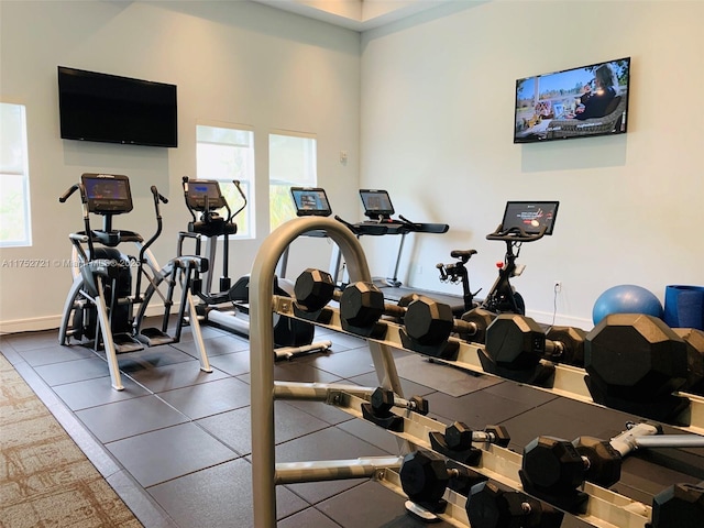 gym featuring plenty of natural light and baseboards