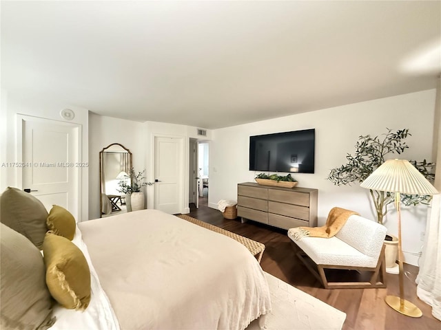 bedroom with visible vents and dark wood-type flooring