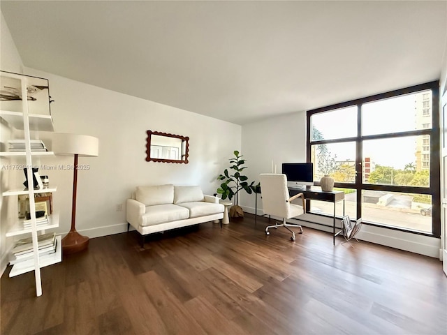 office space with dark wood-style floors and baseboards