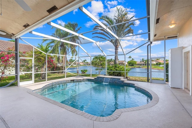 pool with a water view, glass enclosure, and a patio area