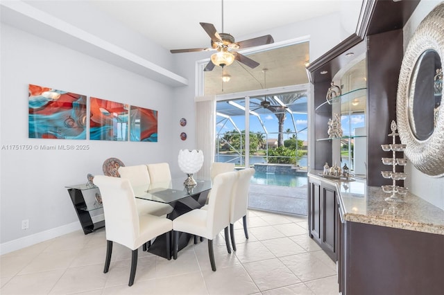 5135 Kensington Cir, Coral Springs, FL 33076 - dining space with a ceiling fan, bar area, light tile patterned floors, and a sunroom