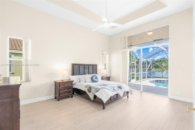 bedroom featuring access to exterior, a sunroom, baseboards, and light wood finished floors