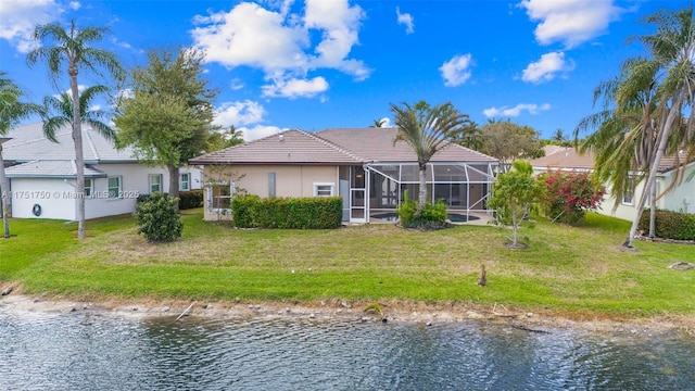5135 Kensington Cir, Coral Springs, FL 33076 - back of property featuring a water view, a tile roof, stucco siding, and a lawn