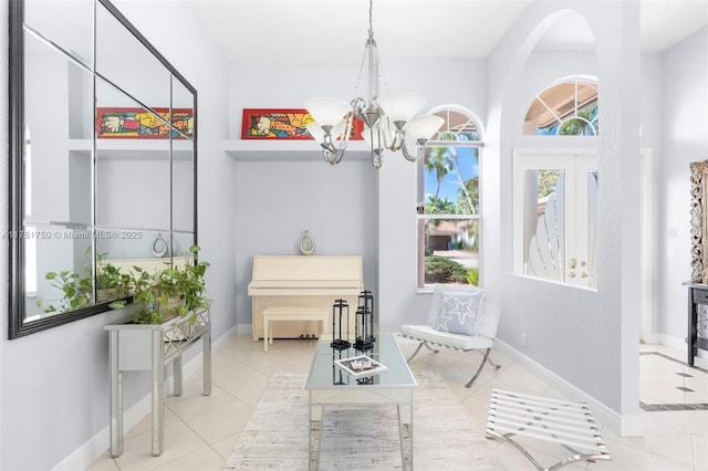 living area featuring light tile patterned floors, baseboards, and a notable chandelier