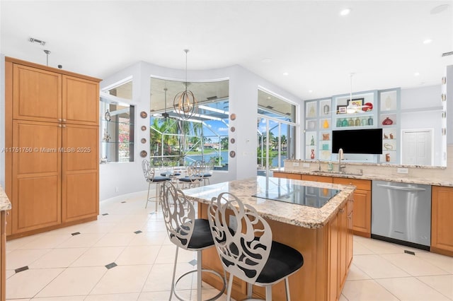 5135 Kensington Cir, Coral Springs, FL 33076 - kitchen with stainless steel dishwasher, black electric cooktop, a center island, light tile patterned floors, and recessed lighting