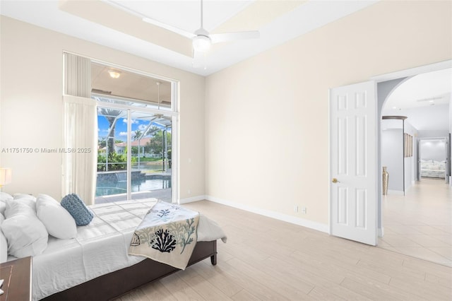5135 Kensington Cir, Coral Springs, FL 33076 - bedroom featuring arched walkways, access to exterior, and light wood-type flooring
