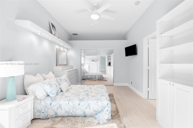 bedroom featuring a ceiling fan, baseboards, visible vents, and light wood finished floors