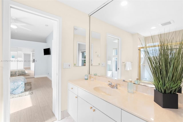 bathroom with visible vents, ceiling fan, wood finished floors, vanity, and recessed lighting