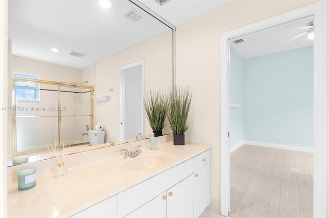 full bath with vanity, a shower stall, visible vents, and baseboards