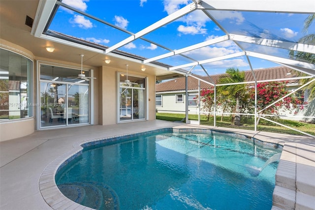 pool with a patio area and glass enclosure