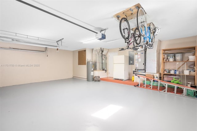 garage featuring electric panel, water heater, a garage door opener, and freestanding refrigerator