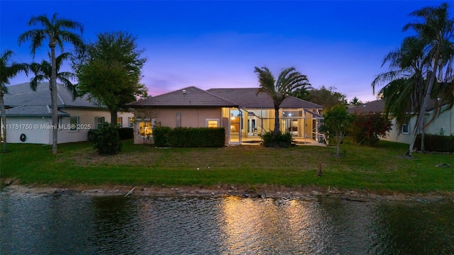 5135 Kensington Cir, Coral Springs, FL 33076 - back of property featuring a water view, a lawn, glass enclosure, a tiled roof, and stucco siding