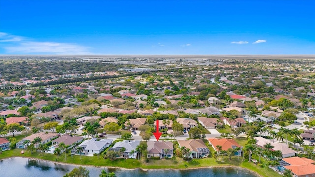 drone / aerial view featuring a water view and a residential view