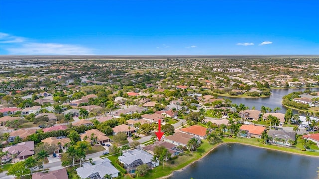 birds eye view of property with a water view and a residential view