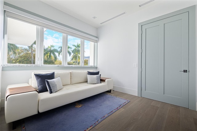 interior space featuring baseboards and dark wood-type flooring