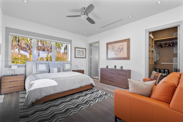 bedroom with a ceiling fan, recessed lighting, visible vents, and wood finished floors