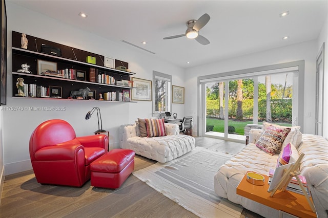 sitting room with a ceiling fan, wood finished floors, and recessed lighting