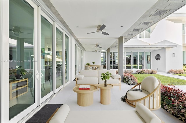 sunroom featuring ceiling fan