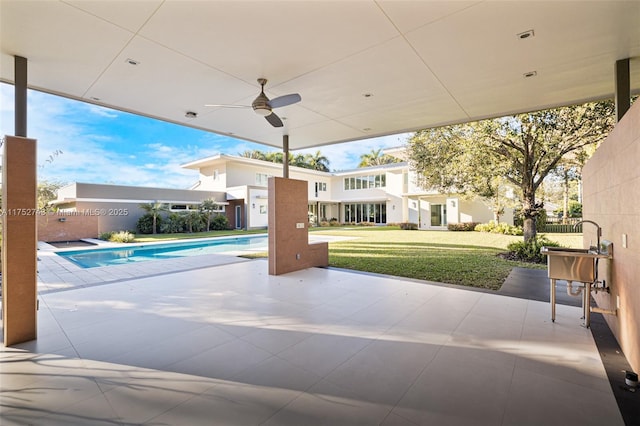 view of patio / terrace featuring a ceiling fan and an outdoor pool