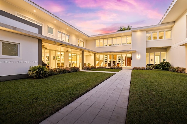 6080 SW 88th St, Pinecrest, FL 33156 - rear view of property with stucco siding and a yard