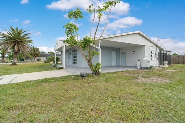 exterior space featuring a carport, a yard, and driveway