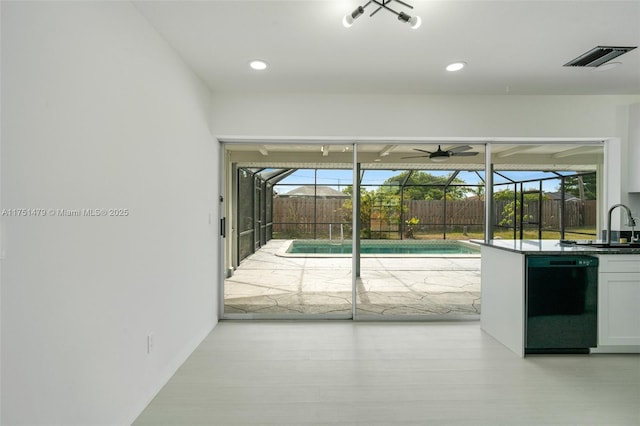 doorway to outside featuring recessed lighting, a sunroom, visible vents, and plenty of natural light