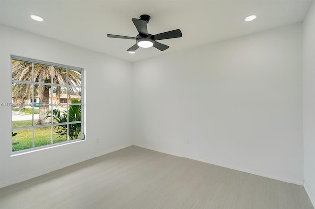 unfurnished room featuring recessed lighting, baseboards, plenty of natural light, and light wood finished floors