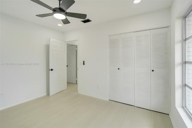 unfurnished bedroom with light wood finished floors, visible vents, a closet, and recessed lighting