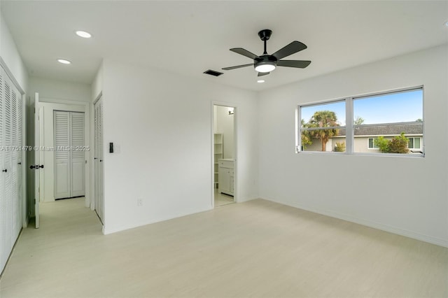 unfurnished bedroom featuring ensuite bathroom, recessed lighting, visible vents, baseboards, and light wood finished floors