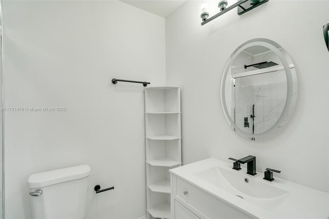 full bath featuring toilet, vanity, and a marble finish shower