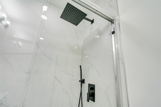 details featuring a marble finish shower