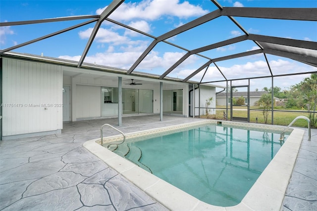 pool with a lanai, a patio area, and ceiling fan