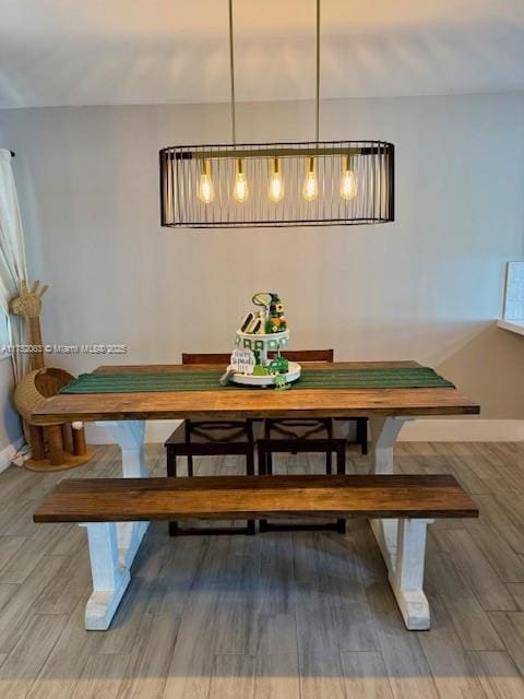 dining room featuring baseboards and wood finished floors