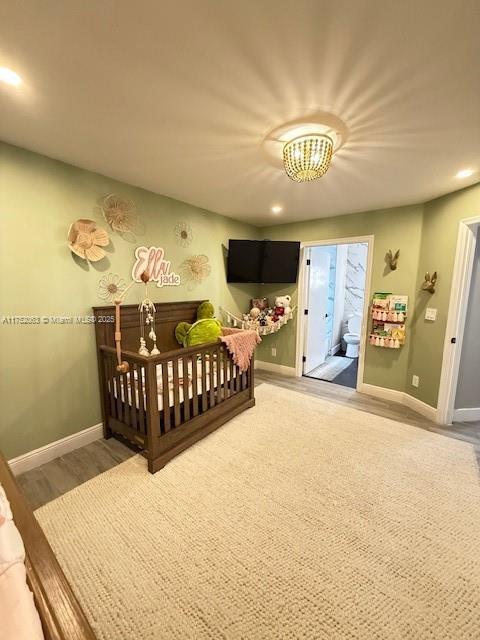 bedroom with baseboards, wood finished floors, and recessed lighting