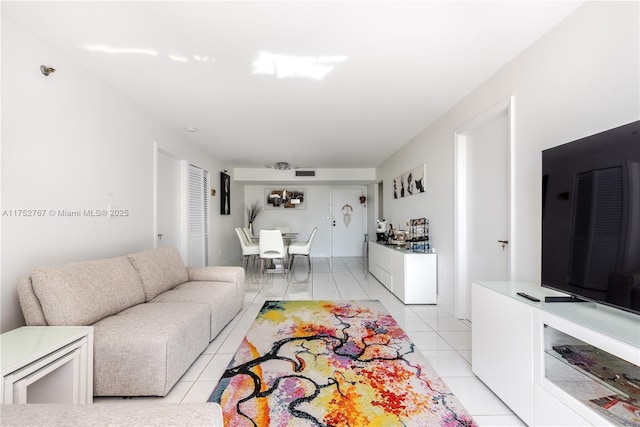 living area with light tile patterned flooring and visible vents