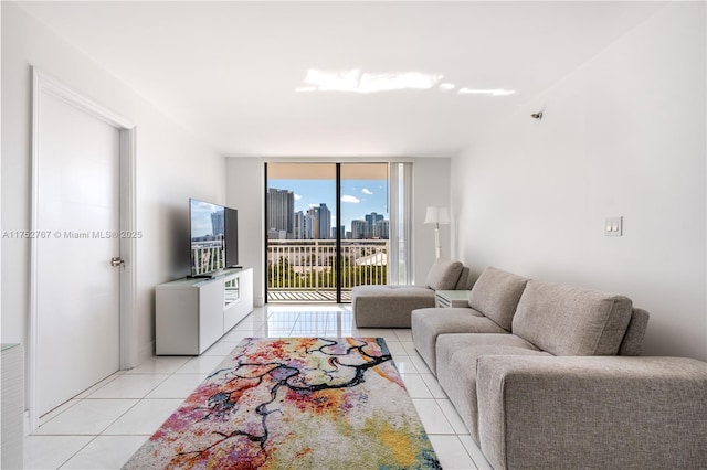 living area featuring expansive windows and light tile patterned flooring