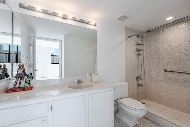 full bathroom with toilet, vanity, visible vents, and a shower stall