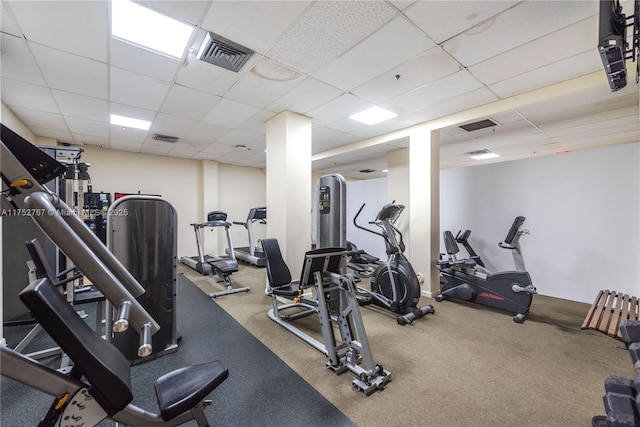 workout area featuring a paneled ceiling and visible vents