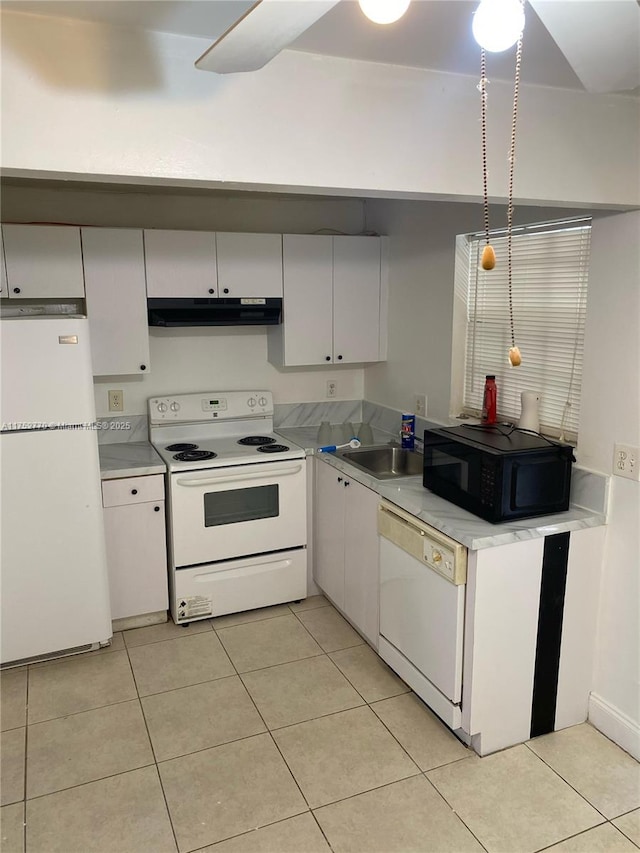 kitchen featuring white appliances, light tile patterned floors, white cabinets, light countertops, and under cabinet range hood