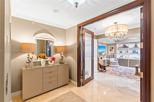 corridor with built in features, marble finish floor, an inviting chandelier, ornamental molding, and baseboards