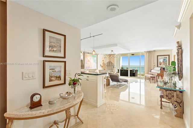 hallway featuring a water view and expansive windows