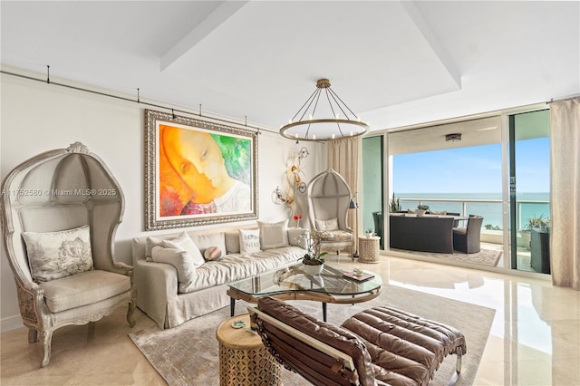 living area featuring a water view, an inviting chandelier, and expansive windows