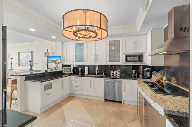 kitchen featuring a sink, white cabinetry, wall chimney range hood, stainless steel dishwasher, and built in microwave