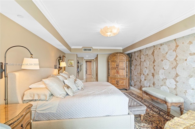 bedroom featuring visible vents, ornamental molding, an accent wall, baseboards, and wallpapered walls